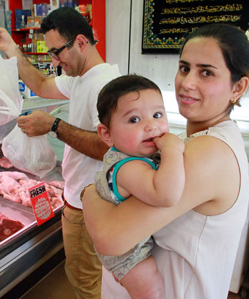 NZ STOCKING UP: Sirwan Mohamadi, his wife Lavin Shirzad and their 5-month-old son, Ariaz, in a halal butcher's shop in Lincoln Rd. KIRK HARGREAVES/Fairfax 